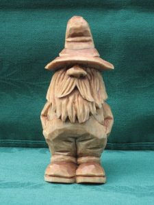 small man out of wood with hat
